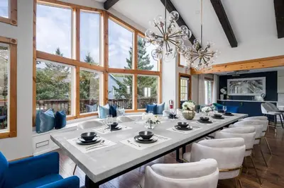 a large dining room with a long table and chairs at 10 Br with Large Hot tubs 130 Proj Screen FirePit in Blue Mountains
