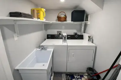 a small kitchen with a sink and a stove at Cozy 3BR Caledon Basement Suite with Private Access, Full Kitchen, WiFi, Laundry, Backyard Basketball Court & Creek Trail, 5 Mins to Brampton! Great for Families & Long Stays! in Caledon