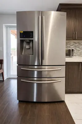 a large stainless steel refrigerator in a kitchen at Cozy 3BR Caledon Basement Suite with Private Access, Full Kitchen, WiFi, Laundry, Backyard Basketball Court & Creek Trail, 5 Mins to Brampton! Great for Families & Long Stays! in Caledon