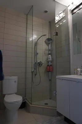 a bathroom with a shower with a toilet and a sink at Downtown Toronto Condo with CN Tower View in Toronto