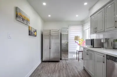 a kitchen with a stainless steel refrigerator at The Rosewood 1 Bedroom Basement Retreat in Vaughan