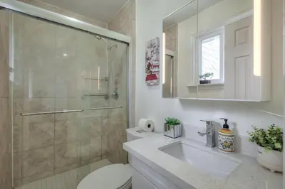 a bathroom with a shower and a toilet and a sink at The Rosewood 1 Bedroom Basement Retreat in Vaughan