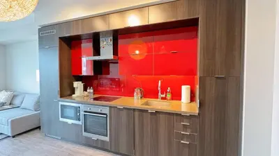 a kitchen with a sink and a red wall at Luxury 1 BR and Den Near CN Tower in Toronto