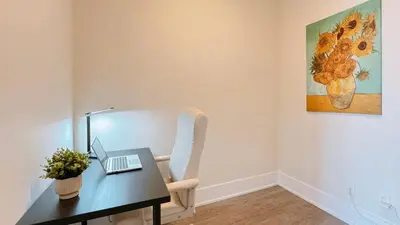 a room with a desk with a laptop on it at Luxury 1 BR and Den Near CN Tower in Toronto