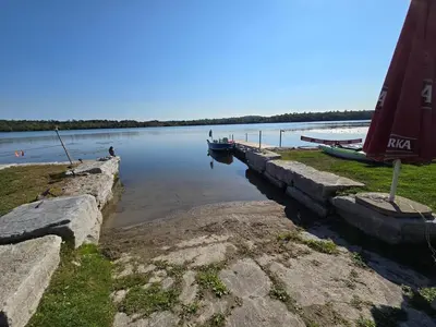 a boat is docked at a dock on a lake at Wheel chair Access, Private Boat Launch in Roseneath