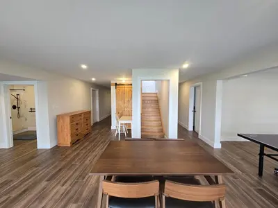 a dining room with a wooden table and chairs at Wheel chair Access, Private Boat Launch in Roseneath