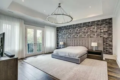 a bedroom with a large bed and a television at Elegant Home with Yard and Comforts in Richmond Hill