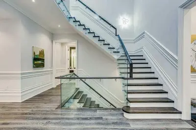 a staircase in a house with a glass railing at Elegant Home with Yard and Comforts in Richmond Hill