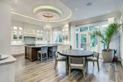 a kitchen with a table and chairs and a dining room at Elegant Home with Yard and Comforts in Richmond Hill