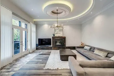a living room with a couch and a fireplace at Elegant Home with Yard and Comforts in Richmond Hill