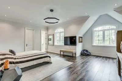 a bedroom with a bed and a flat screen tv at Elegant Home with Yard and Comforts in Richmond Hill