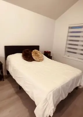 a white bed in a bedroom with a window at Private Room In Luxury Home in Innisfil