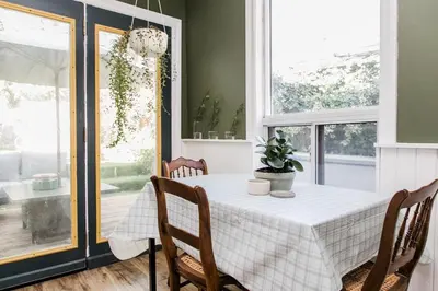 a dining room with a table and chairs and a window at The Parkdale Cottage in Toronto
