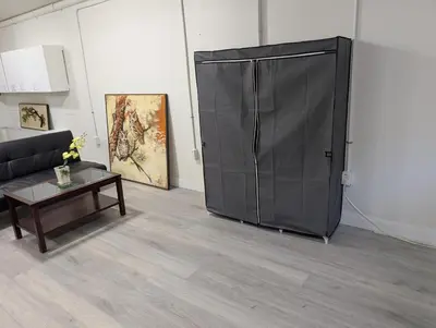 a large black door in a room with a couch and a table at Cozy Bachelor Unit in Guelph