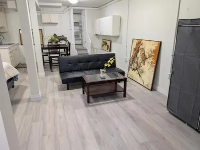 a living room with a couch and a table at Cozy Bachelor Unit in Guelph