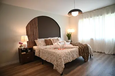 a bedroom with a large bed and a large window at Modern 3Bed Home 10 Mins to Niagra Falls in Thorold