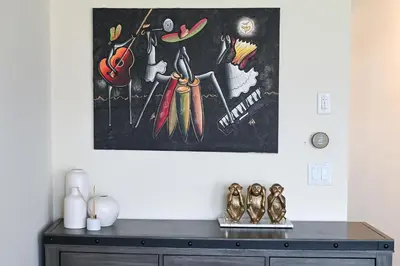 a painting hanging on a wall above a dresser at Modern 3Bed Home 10 Mins to Niagra Falls in Thorold