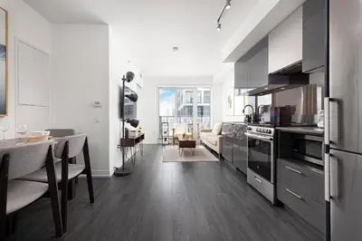 a kitchen with a table and a dining room at Classy and Luxury 2 bedroom apartment 5 mins to Dundas Square in Toronto