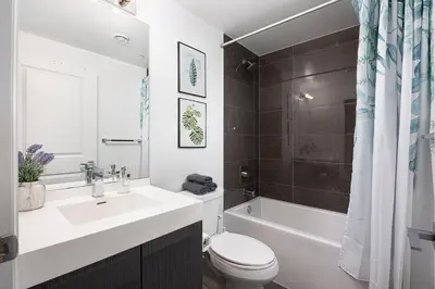 a bathroom with a sink and a toilet and a tub at Classy and Luxury 2 bedroom apartment 5 mins to Dundas Square in Toronto