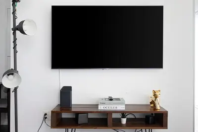 a flat screen tv hanging on a white wall at Classy and Luxury 2 bedroom apartment 5 mins to Dundas Square in Toronto