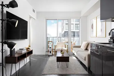 a living room with a couch and a table at Classy and Luxury 2 bedroom apartment 5 mins to Dundas Square in Toronto
