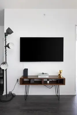 a flat screen tv on a white wall in a living room at Classy and Luxury 2 bedroom apartment 5 mins to Dundas Square in Toronto