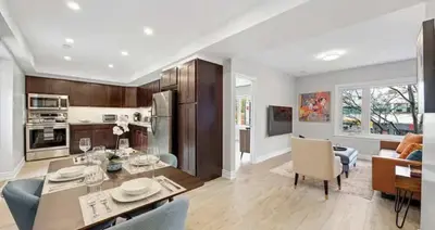 a kitchen and living room with a table and a dining room at Casa Hotel Contemporary 2BR Suite w Patio & BBQ in Toronto