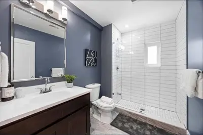 a bathroom with a sink and a toilet and a shower at Casa Hotel Contemporary 2BR Suite w Patio & BBQ in Toronto