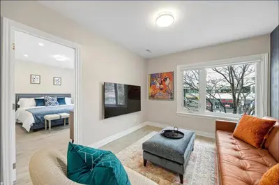 a living room with a couch and a bed at Casa Hotel Contemporary 2BR Suite w Patio & BBQ in Toronto
