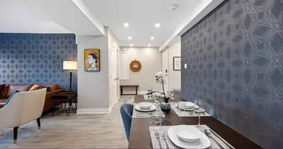 a living room with a dining table and a couch at Casa Hotel Contemporary 2BR Suite w Patio & BBQ in Toronto