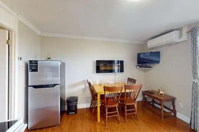 a kitchen with a table and a refrigerator at The Driftwood Deck 5B in Wasaga Beach