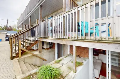 an external view of a building with stairs and chairs at The Driftwood Deck 5B in Wasaga Beach
