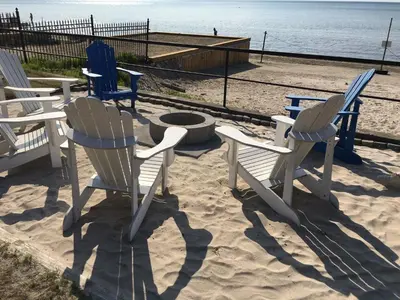 a group of chairs and a fire pit on the beach at The Driftwood Deck 5B in Wasaga Beach