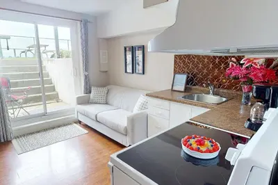 a kitchen and living room with a bowl of candy on the counter at The Driftwood Deck 5B in Wasaga Beach