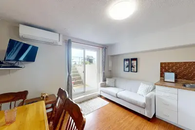 a living room with a couch and a table at The Driftwood Deck 5B in Wasaga Beach