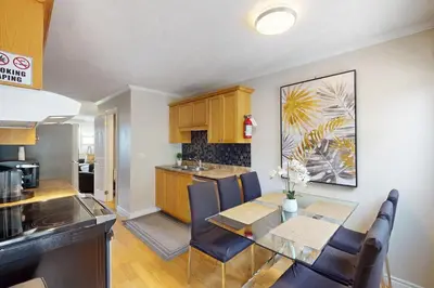 a kitchen and dining room with a table and chairs at The Driftwood Deck 5A in Wasaga Beach