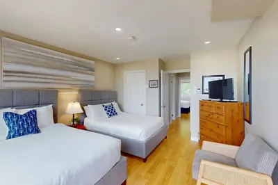 a bedroom with a bed and a tv and a couch at The Driftwood Deck 5A in Wasaga Beach
