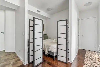a bedroom with white walls and a bed at Spacious 2BR Condo Downtown, Lakeshore, Parking in Toronto