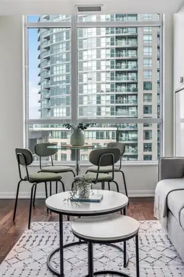 a living room with a couch and tables and windows at Spacious 2BR Condo Downtown, Lakeshore, Parking in Toronto