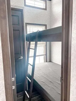 a bunk bed in a room with a window at Bobcaygeon Shores Cottage Resort in Kawartha Lakes