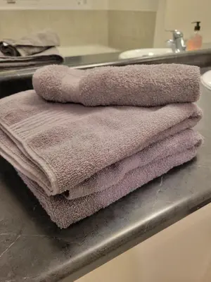 a pile of towels sitting on top of a sink at 15 mins from Niagara falls-5 Bedrooms Inn in Thorold