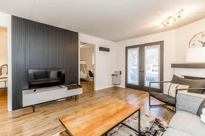 a living room with a couch and a tv at The Landing Pad - Condo in Collingwood in Collingwood