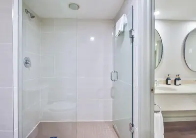 a bathroom with a shower with a glass door at Highland Hideaway 1BR King Suite in Shanty Bay