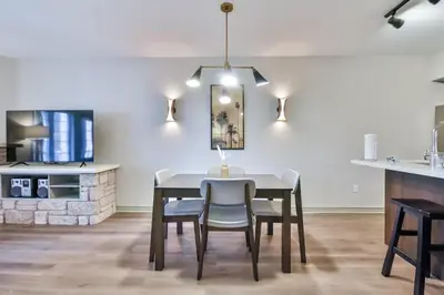 a kitchen and dining room with a table and chairs at Highland Hideaway 1BR King Suite in Shanty Bay