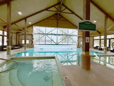a large indoor swimming pool with a large swimming pool at King Suite heated Pool Sauna and Kitchen in Shanty Bay