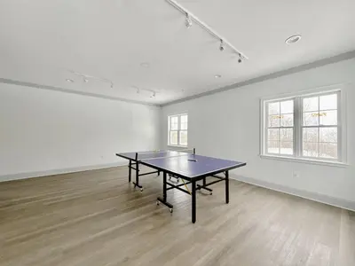 a ping pong table in an empty room at King Suite heated Pool Sauna and Kitchen in Shanty Bay
