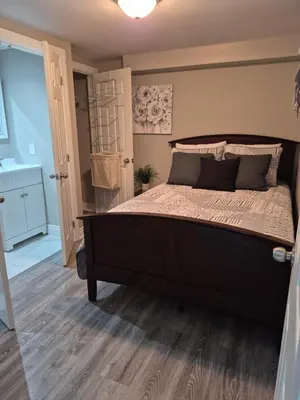 a bedroom with a large bed and a bathroom at Whitby one bedroom apartment in Whitby