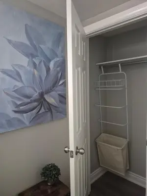 a painting of a flower on the wall in a bathroom at Whitby one bedroom apartment in Whitby