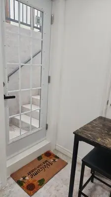 a room with a door and a table and a window at Entire Studio Guest Suite in Kitchener in Kitchener