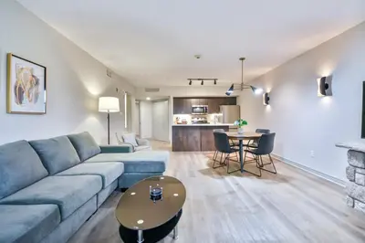 a living room with a blue couch and a table at Hideaway 2BR Condo Pool & Heated Pool in Shanty Bay